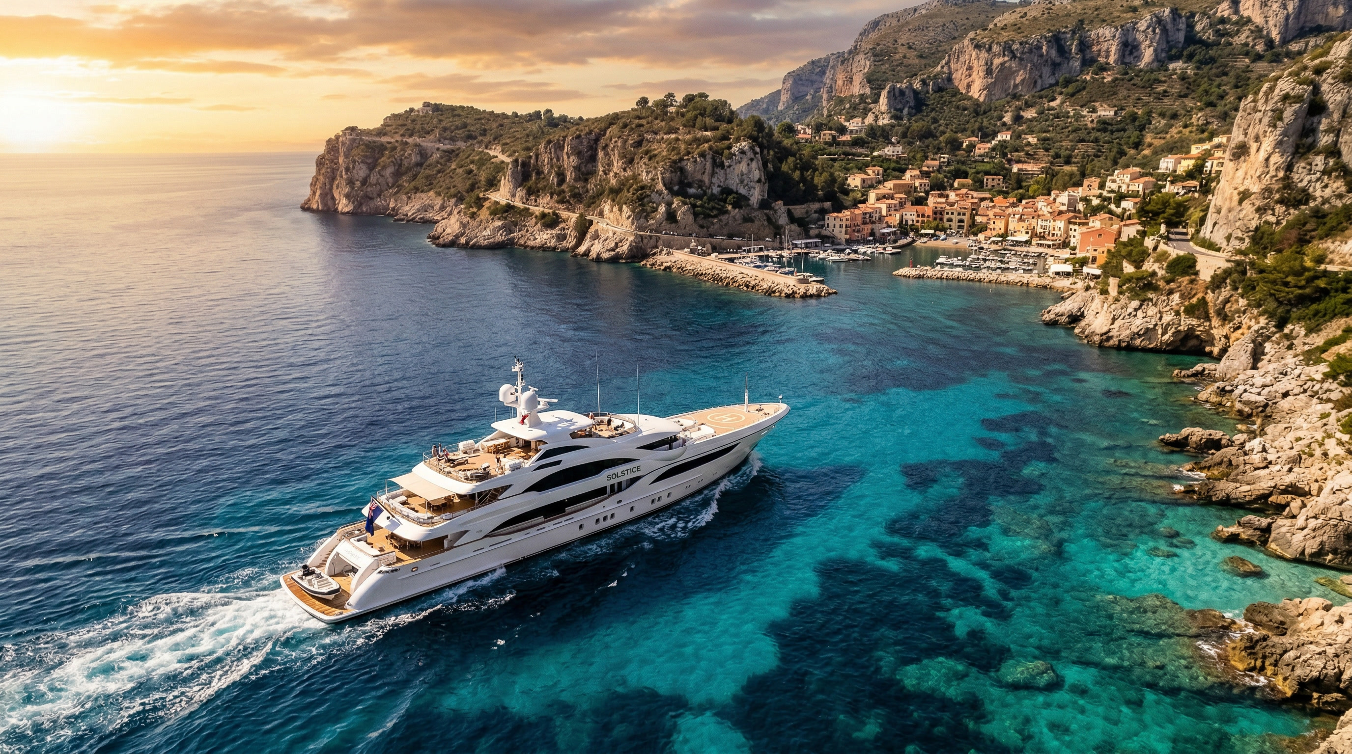 Luxury superyacht cruising along the Mediterranean coastline at golden hour